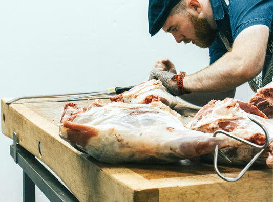 butcher cutting beef to make beef tallow