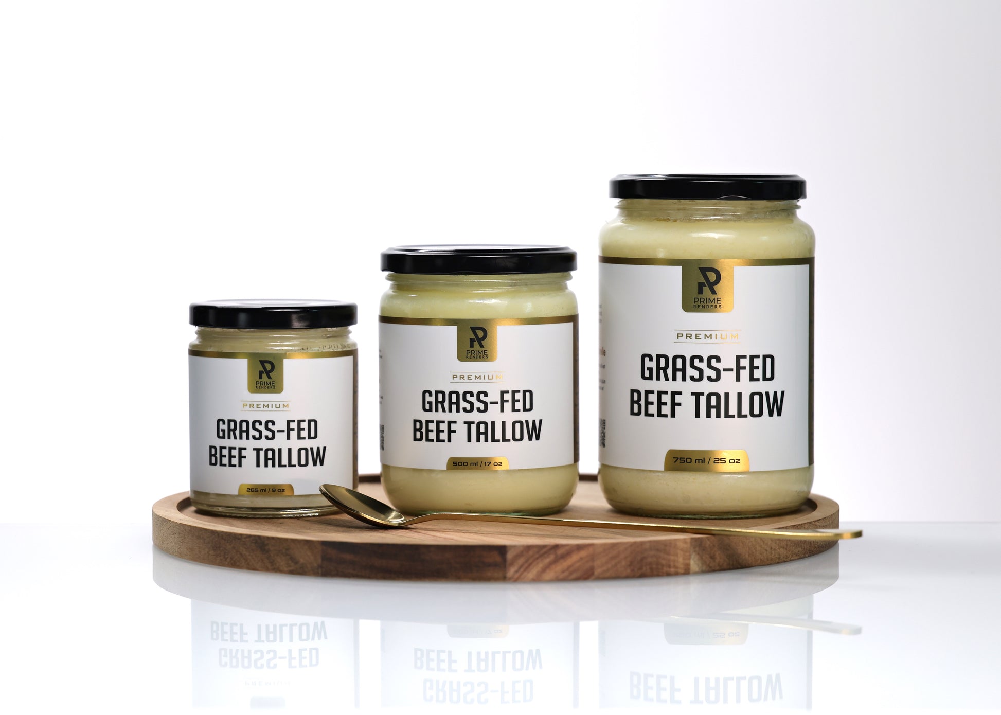 Three jars of grass-fed beef tallow on a wooden tray with a white background