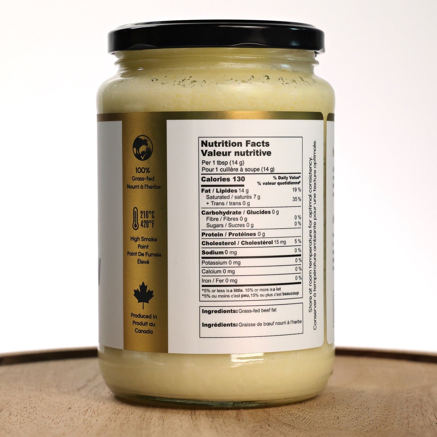 Jar of grass-fed beef tallow on a wooden tray with a white background