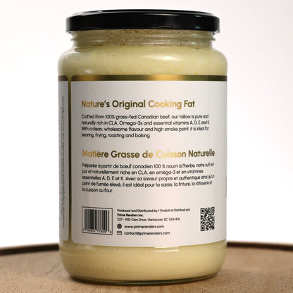 Jar of beef tallow cooking fat on a wooden board with a white background