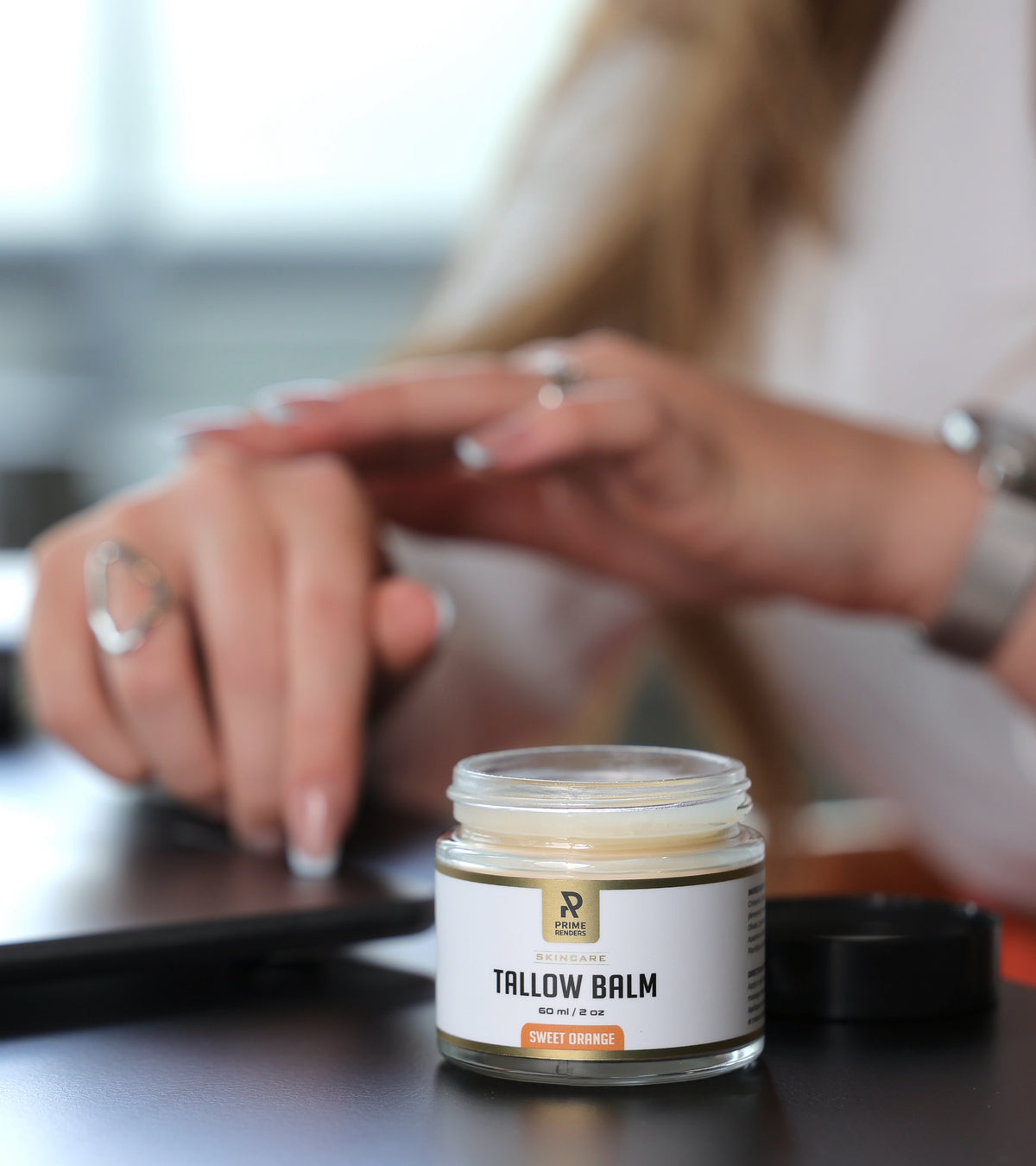 applying beef tallow sweet orange balm to hand