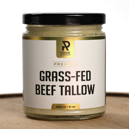 Jar of grass-fed beef tallow with a Prime Renders brand label on a wooden surface.