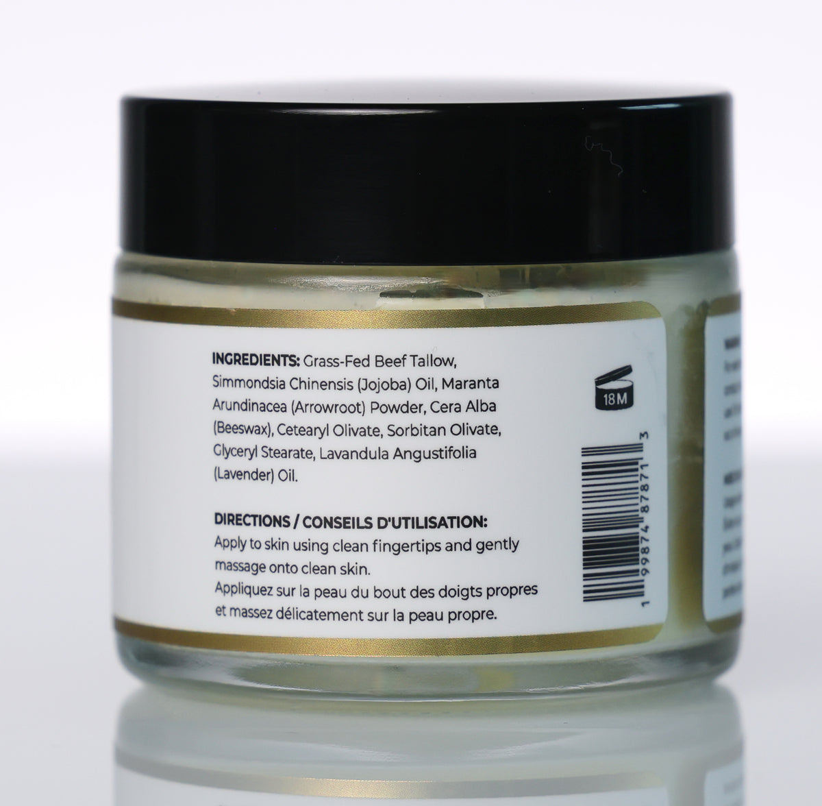 A jar of prime renders beef tallow balm a black lid and a white label showing ingredients and directions, photographed on a clean white background with a soft reflection.