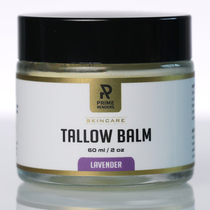 A jar of Prime Renders Skincare Tallow Balm in Lavender, featuring a white label with gold accents and a black lid, set against a clean white background with a soft reflection.