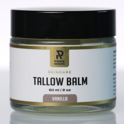 A jar of Prime Renders Skincare Tallow Balm in Vanilla, featuring a white label with gold accents and a black lid, set against a clean white background with a soft reflection.